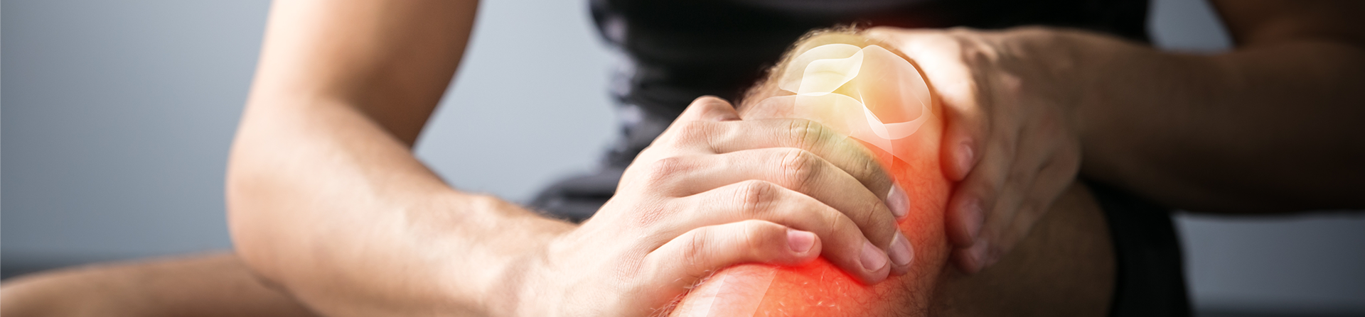 A person massaging their injured knee