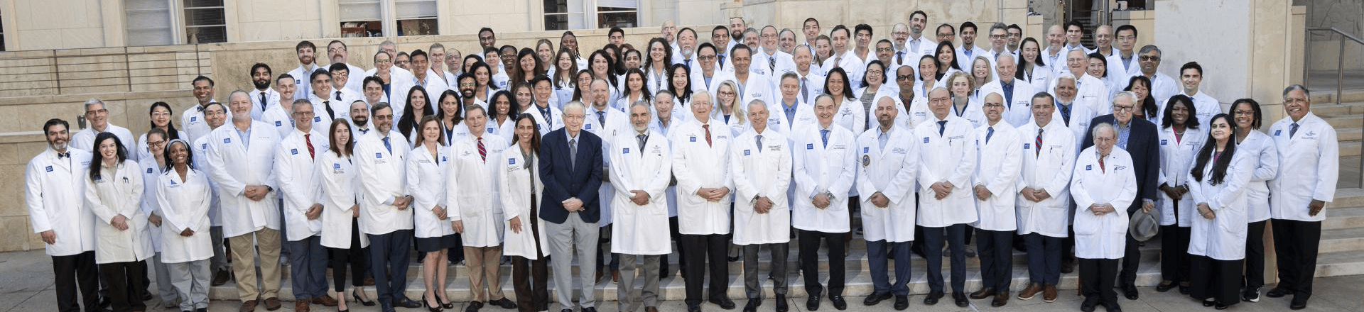 A few dozen members of the Department of Surgery lined up outside on stairs