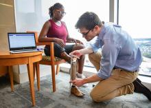 Doctor fitting patient with prosthetic leg