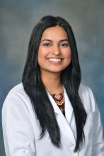 woman in white coat smiling
