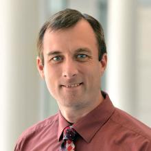 Woman smiling in front of grey background