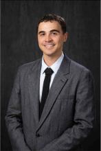 man in gray suit smiling