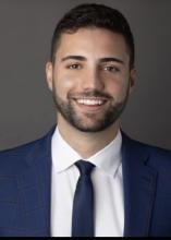 man in navy blue suit smiling