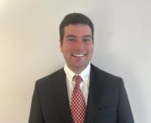 man with red tie smiling