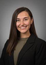 woman with black blazer smiling
