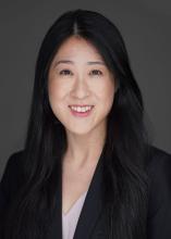 woman with long black hair smiling