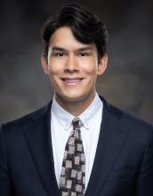 man with dark blue suit smiling