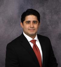 man in a suit smiling