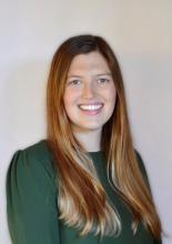 woman in a greet top smiling