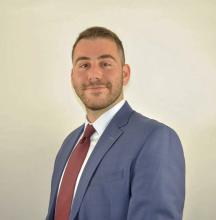 man in blue suit smiling
