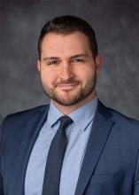 man in blue suit and tie smiling