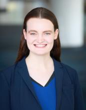 woman in blue suit smiling
