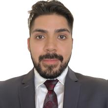 man in grey suit smiling