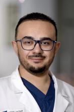 man with short hair and glasses smiling