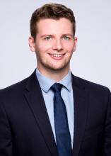 man in a blue suit smiling