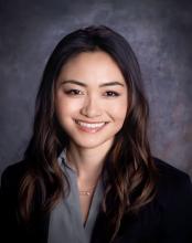 woman in grey top smiling