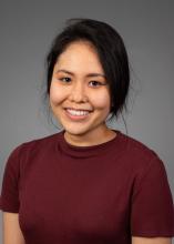 woman in a wine red top smiling