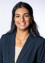 woman in navy suit smiling