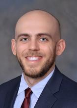 man in a blue suit smiling