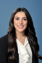 woman with long dark wavy hair smiling