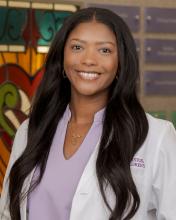 woman doctor with long black hair smiling