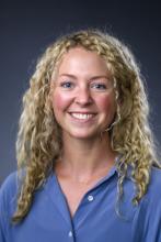 woman with curly blonde hair smiling