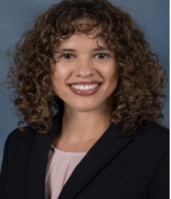 woman with shoulder length curly hair smiling