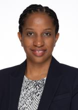 woman with tied back braided hair smiling