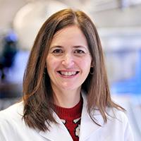 woman with shoulder length blonde hair smiling