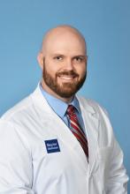 bald man with a beard smiling