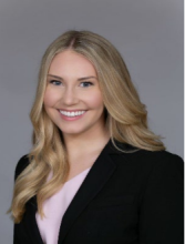woman with long curled blonde hair smiling