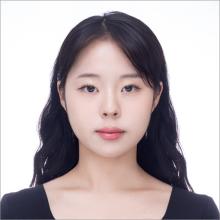 woman with dark side parted hair smiling