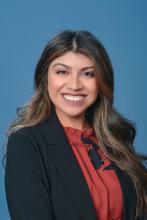 woman with dark, highlighted hair smiling