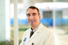 man in white doctor coat smiling