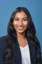 woman with long dark curled hair smiling