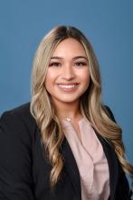 woman with long curled blonde hair smiling