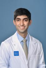 man with dark hair smiling