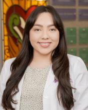 woman with long dark hair and side bangs smiling