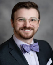 man in a bowtie with glasses smiling