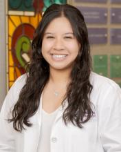 woman with curly dark hair smiling