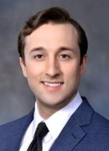 man in a blue blazer smiling