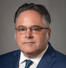 man with glasses smiling