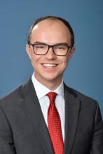 man with dark glasses smiling