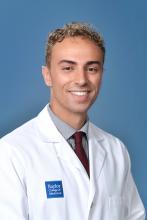 man with blonde short hair smiling