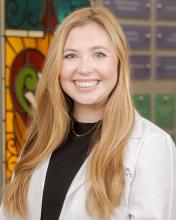 woman with long straight blonde hair smiling