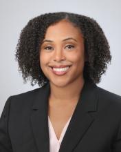 woman with short curly hair smiling