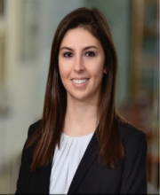 woman in black blazer smiling