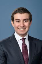 man with short brown hair smiling