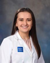 woman with long brown straight hair smiling