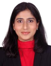 woman with red turtle neck smiling